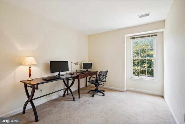 home office featuring light carpet, visible vents, and baseboards