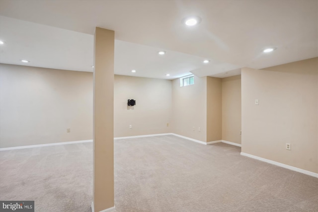 basement with recessed lighting, light carpet, and baseboards