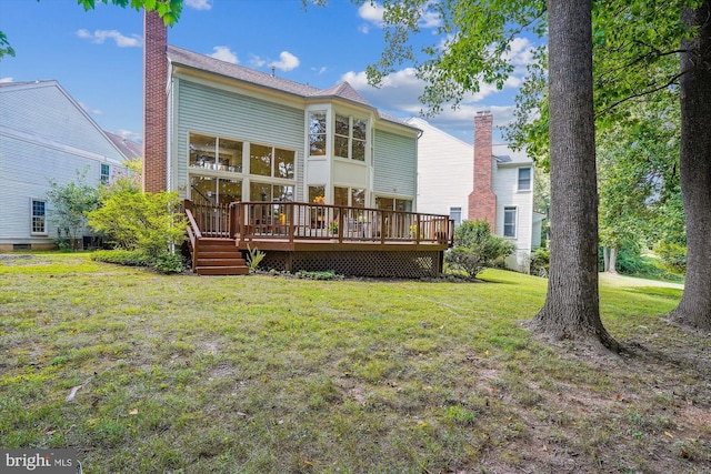 back of house with a deck, a lawn, and a chimney