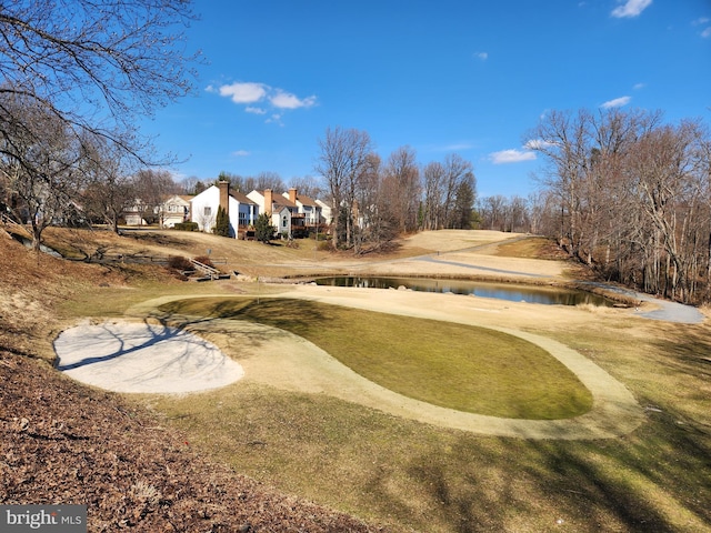 view of home's community featuring a water view and a lawn