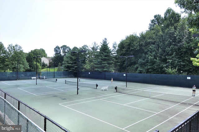 view of tennis court featuring fence