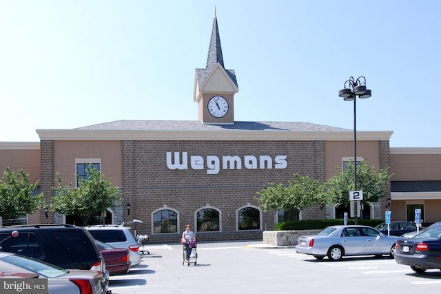 view of building exterior with uncovered parking