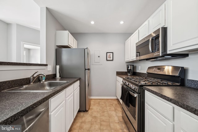 kitchen featuring dark countertops, stainless steel appliances, and a sink