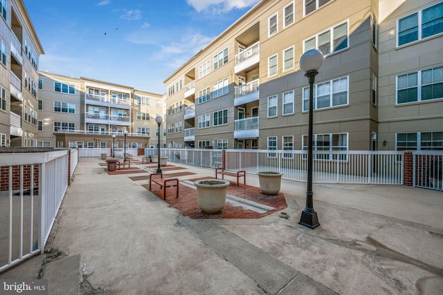 view of property's community with a patio and fence