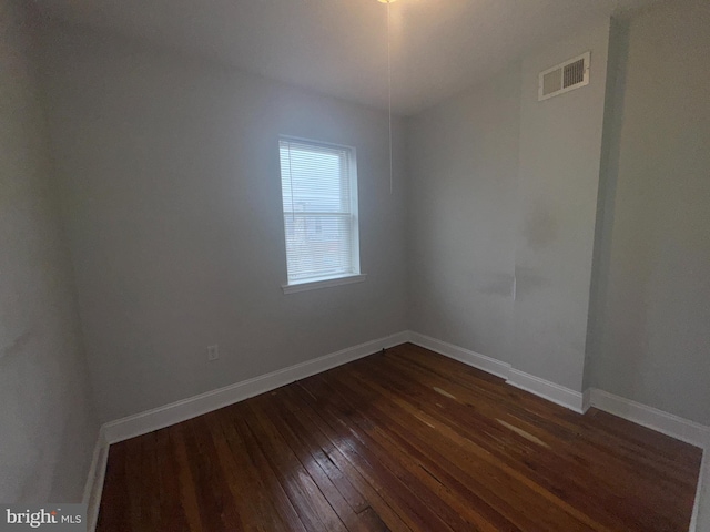 spare room featuring dark hardwood / wood-style floors