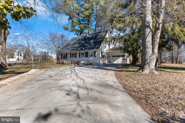 new england style home featuring a garage