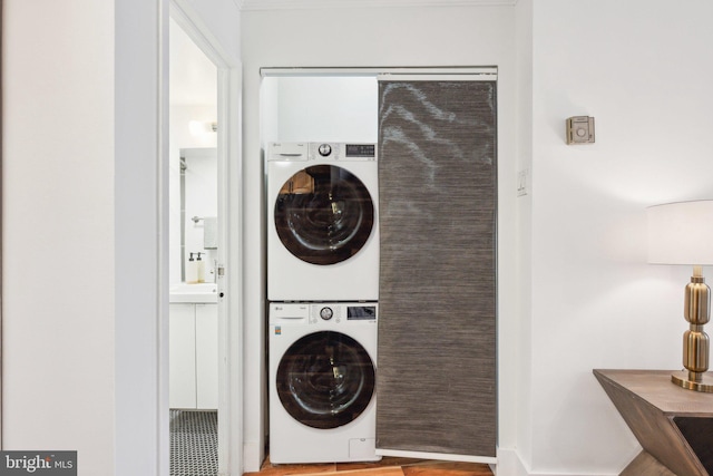 laundry area with stacked washer and clothes dryer