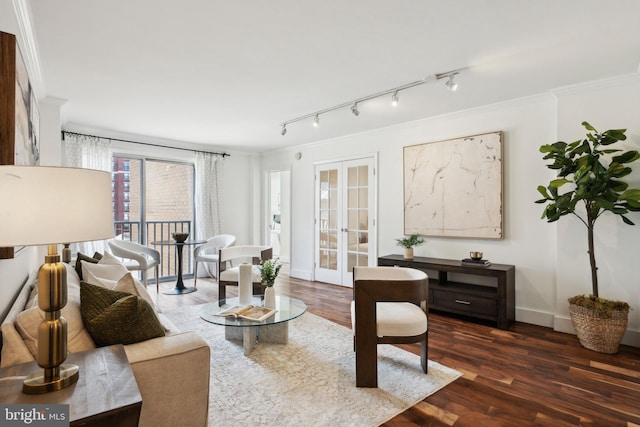 living room with french doors, track lighting, ornamental molding, and dark hardwood / wood-style flooring