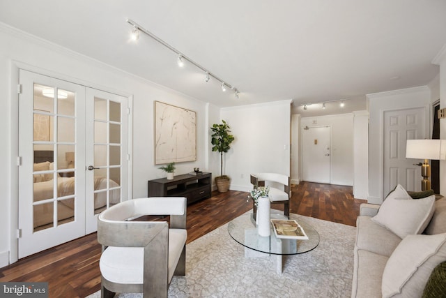 living room with crown molding, dark hardwood / wood-style flooring, and french doors