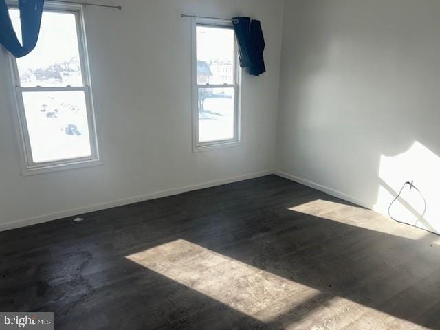 unfurnished room featuring dark hardwood / wood-style floors