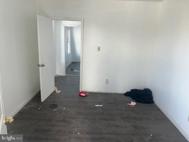 empty room with dark hardwood / wood-style floors