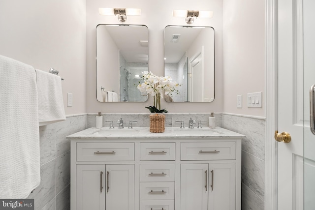 bathroom featuring tile walls and vanity