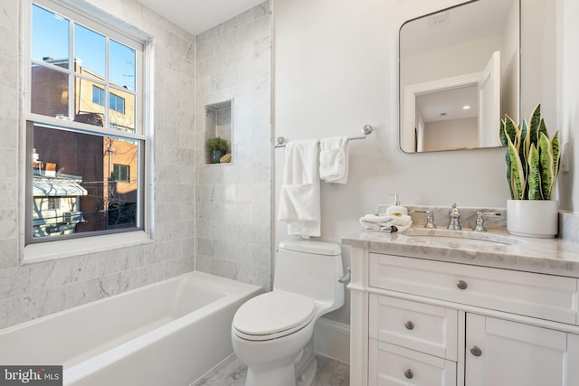 full bathroom featuring toilet, vanity, and tiled shower / bath combo