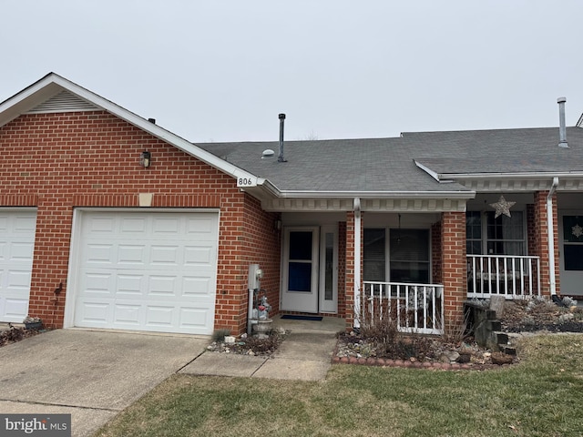 single story home with a porch, a garage, and a front yard