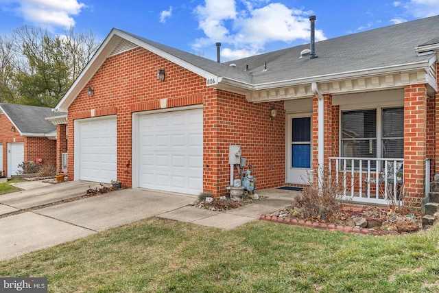 view of front of property with a garage, covered porch, and a front lawn