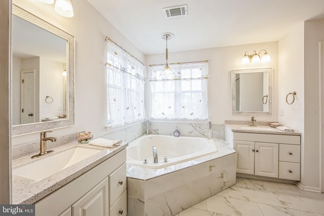 bathroom with vanity and tiled bath