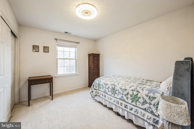 bedroom featuring light colored carpet and a closet