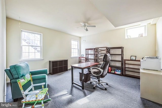 carpeted office space with ceiling fan