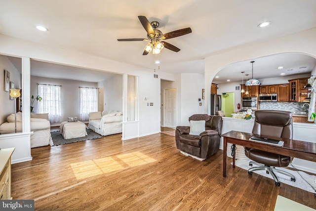 living room featuring ceiling fan and hardwood / wood-style floors