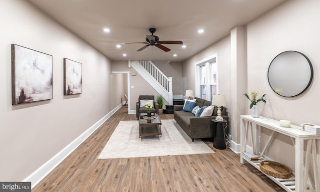 living room with wood-type flooring and ceiling fan