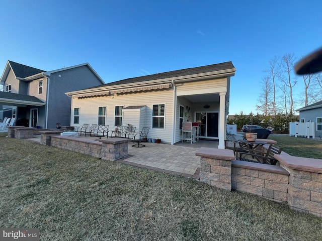 rear view of property featuring a patio area and a yard