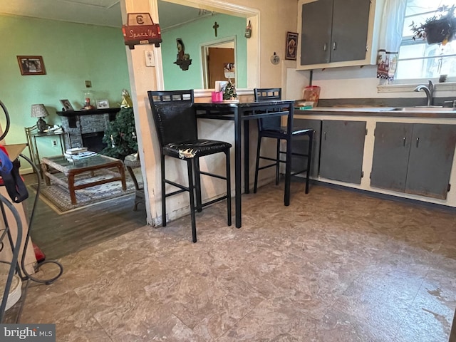 kitchen featuring sink and a fireplace