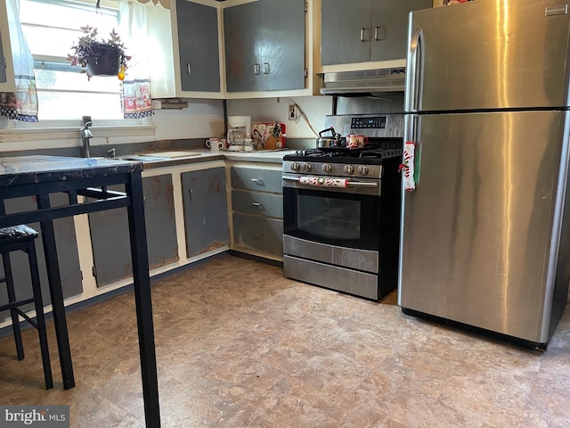 kitchen with appliances with stainless steel finishes and gray cabinetry