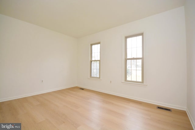 spare room with light hardwood / wood-style floors