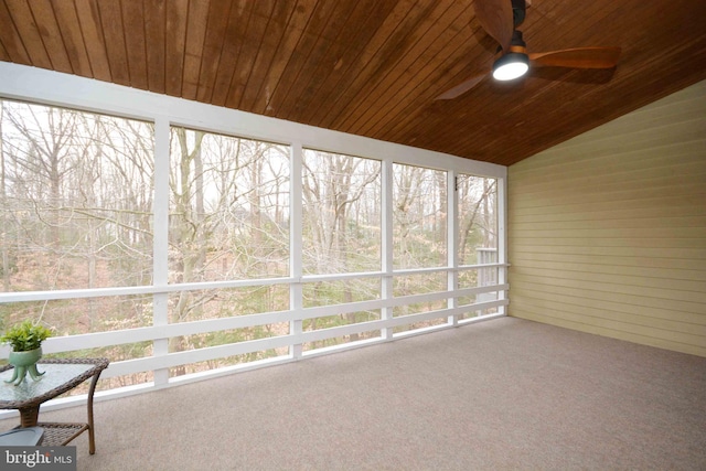 unfurnished sunroom featuring lofted ceiling, wooden ceiling, and ceiling fan