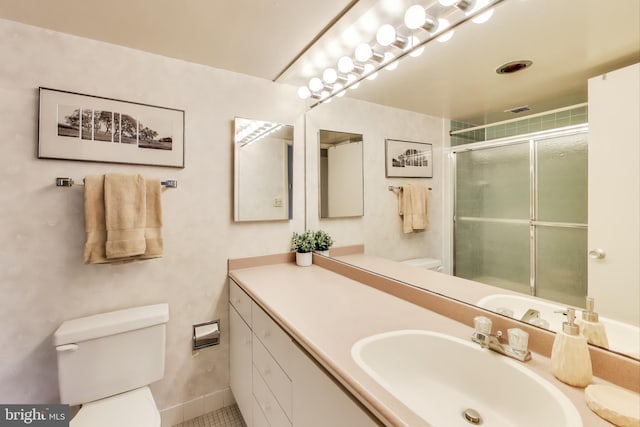 bathroom with vanity, toilet, and a shower with shower door