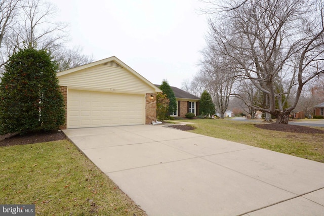 single story home featuring a garage and a front lawn