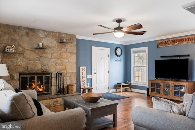 living room with ornamental molding, a fireplace, wood finished floors, and baseboards