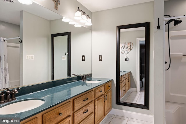 full bathroom with double vanity, a sink, visible vents, and tile patterned floors