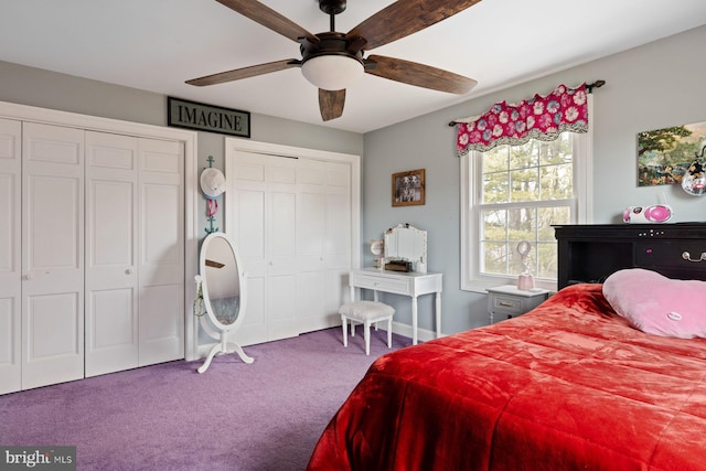 carpeted bedroom featuring multiple closets and ceiling fan