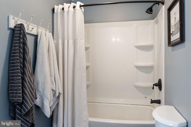 full bath featuring toilet and shower / bath combo with shower curtain