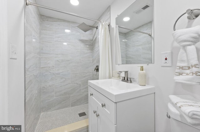 full bathroom featuring recessed lighting, visible vents, a tile shower, and vanity