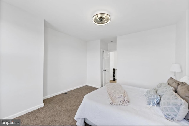 bedroom featuring baseboards and carpet flooring