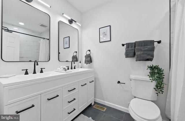 bathroom with visible vents, toilet, a sink, baseboards, and tile patterned floors