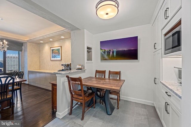 dining area featuring a notable chandelier, recessed lighting, and baseboards