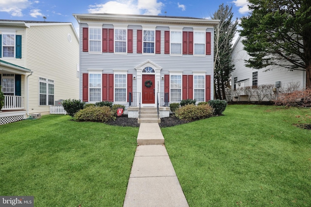 colonial home featuring a front yard