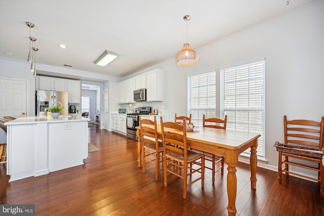 dining area featuring recessed lighting, dark wood-type flooring, and baseboards