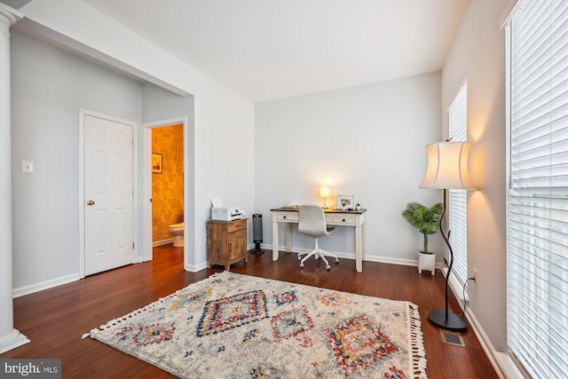 office with visible vents, baseboards, and wood finished floors