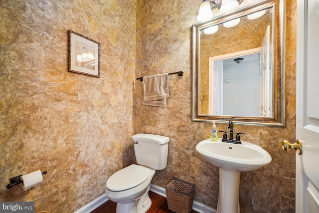 half bath with toilet and baseboards