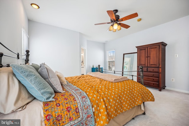 bedroom featuring light colored carpet and baseboards