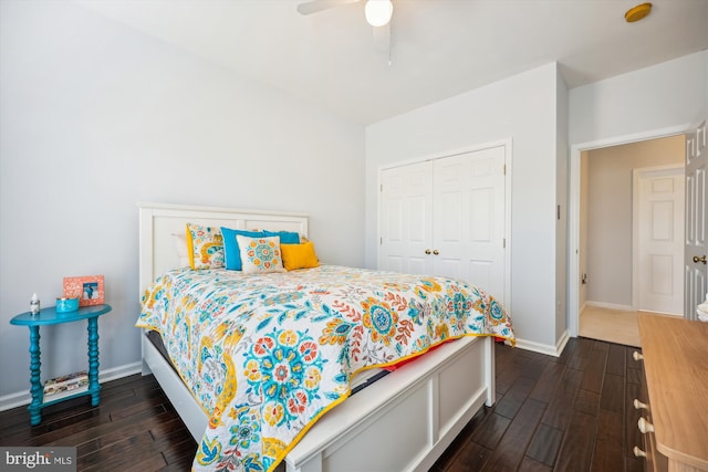 bedroom featuring a closet, baseboards, a ceiling fan, and dark wood-style flooring