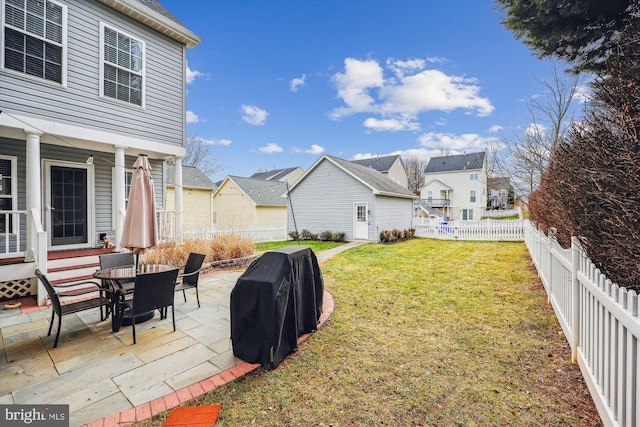 view of yard featuring a residential view, entry steps, a fenced backyard, and a patio area