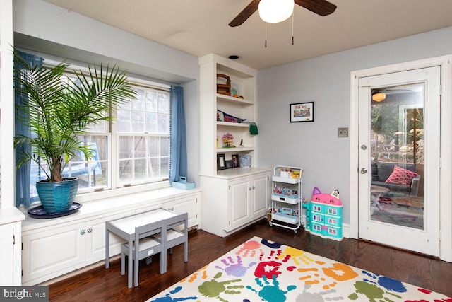 recreation room featuring dark wood-type flooring and ceiling fan