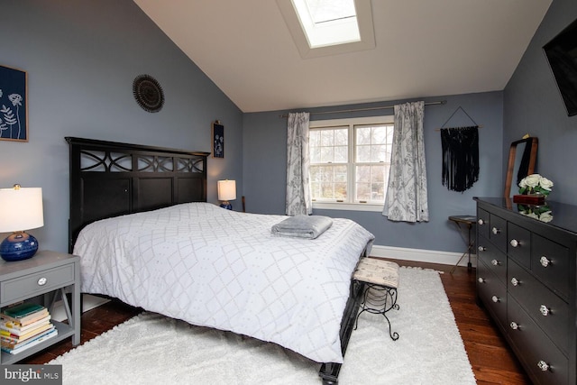 bedroom with dark hardwood / wood-style floors and vaulted ceiling with skylight