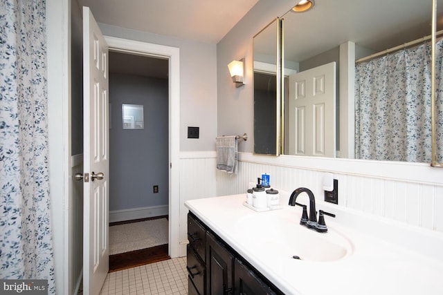 bathroom with tile patterned floors, curtained shower, and vanity