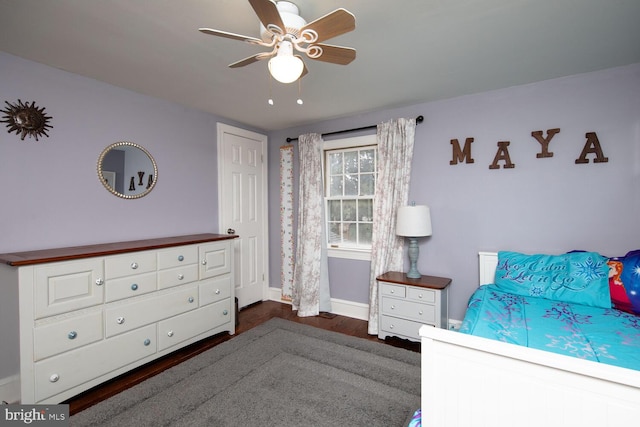 bedroom with dark hardwood / wood-style floors and ceiling fan